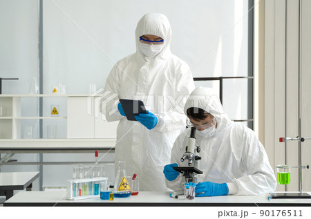 Epidemiological researcher in virus protective cloth working in laboratory. Omicron strain testing process, Coronavirus disease 2019. Epidemiological researcher in virus protective cloth working in laboratory. Omicron strain testing process, Coronavirus disease 2019. 90176511