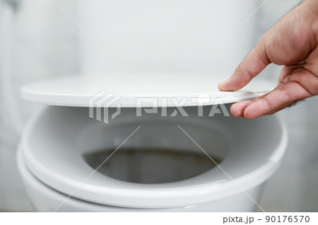 man's hand opening the toilet lid man's hand opening the toilet lid 90176570
