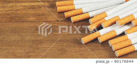 image of several commercially made cigarettes. pile cigarette on wooden. or Non smoking campaign concept, tobacco image of several commercially made cigarettes. pile cigarette on wooden. or Non smoking campaign concept, tobacco 90176644