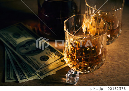 two glasses of iced whiskey and dollars two glasses of iced whiskey and dollars 90182578