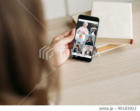 Digital study. Mobile video class. Modern education technology. Senior female business coach teaching students on smartphone screen at workplace with books. 90183922
