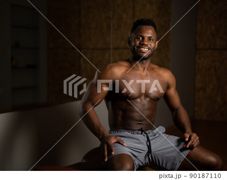 Handsome afro american shirtless man posing in the gym. Handsome afro american shirtless man posing in the gym. 90187110