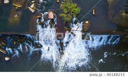 Looking down at manmade dam for river with waterfall Looking down at manmade dam for river with waterfall 90188233