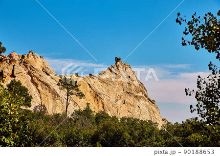 Landscape of rock peaks against trees and blue sky Landscape of rock peaks against trees and blue sky 90188653