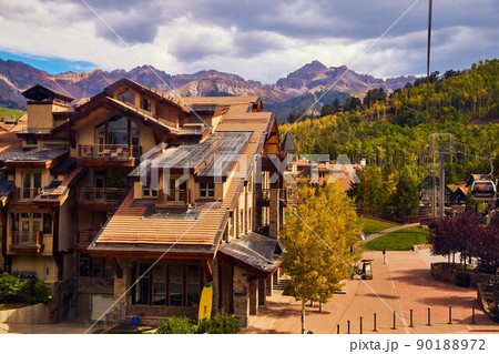 Large cabin housing in the mountains with hills of aspen in background 90188972
