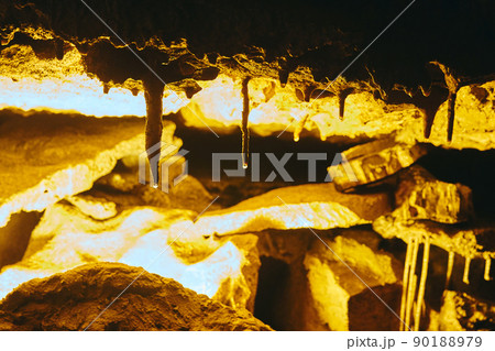 Close up detail of cave formation stalactites with water on tips forming Close up detail of cave formation stalactites with water on tips forming 90188979