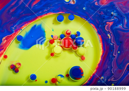 Tiny colorful spheres of red, yellow, and blue on mystical liquid surface 90188999