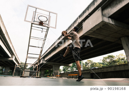 Two caucasian men pratice baskegball in court at urban street. Two caucasian men pratice baskegball in court at urban street. 90198168