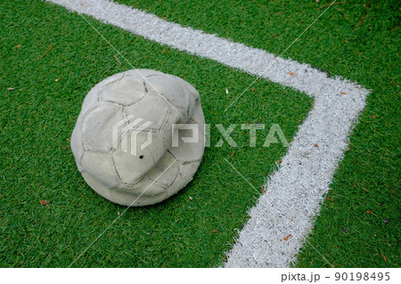 deflated soccer ball on green grass sport field. deflated soccer ball on green grass sport field. 90198495