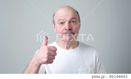 Happy handsome man showing thumbs up Happy handsome man showing thumbs up 90198665