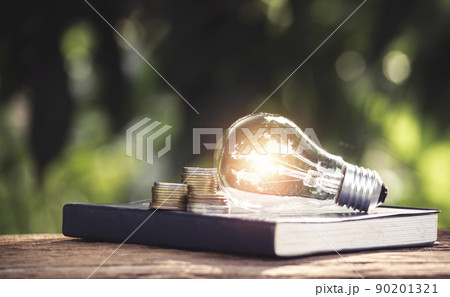 Light bulb and a book on table and copy space for insert text. Light bulb and a book on table and copy space for insert text. 90201321