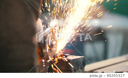 Industrial concept. Construction site. The man worker grinding. Fire sparkles 90205327