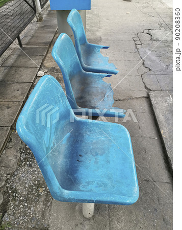 broken blue chair at the bus stop 90208360