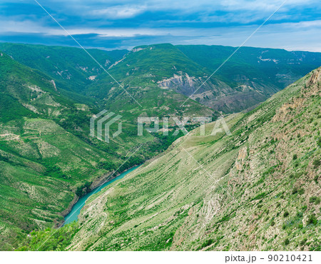 Mountain landscape in the Caucasus in Dagestan, view of the canyon of the Sulak River with the village of Old Zubutli in the distance on the slope Mountain landscape in the Caucasus in Dagestan, view of the canyon of the Sulak River with the village of Old Zubutli in the distance on the slope 90210421