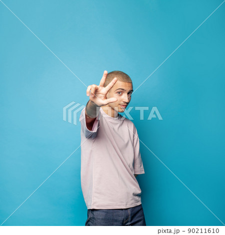 Portrait of student man showing 3 three on blue background 90211610
