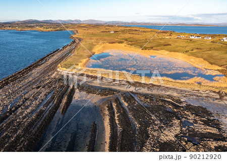 Aerial view of the amazing rocky coast at Rahan Far by Dunkineely, St Johns Point in County Donegal - Ireland. Aerial view of the amazing rocky coast at Rahan Far by Dunkineely, St Johns Point in County Donegal - Ireland. 90212920