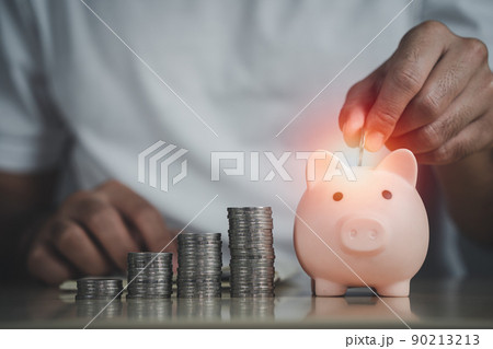 Man hand holding coin and piggy bank on table, saving money wealth and financial concept, Business, finance, investment, Financial planning. Business financial saving for future concept. 90213213