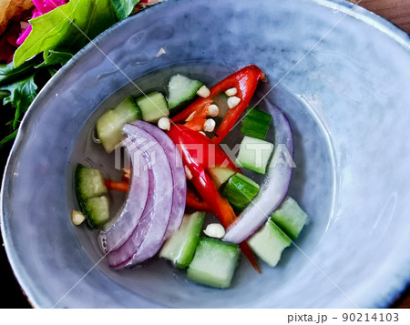 Cucumber onions spicy red chilli relish in clear white vinegar to eat with Satay curry 90214103