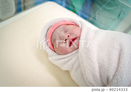 First day of Asian newborn baby sleep in Incubator at nursery room. First day of Asian newborn baby sleep in Incubator at nursery room. 90214333