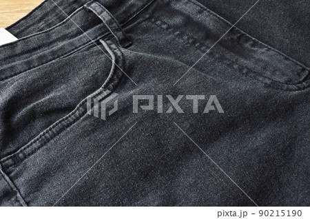 Zipper pocket and buttons close-up detail of light black jeans 90215190