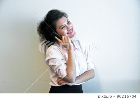 Business woman make a call on white background Business woman make a call on white background 90216704