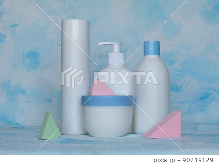 Bottles for cosmetic products without a label. Facial skin care concept. Background texture. Sponges for makeup 90219129