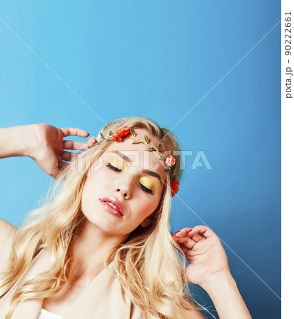 young blond woman dressed like ancient greek godess, beautiful girl hands manicured red nails on blue background copyspace close up young blond woman dressed like ancient greek godess, beautiful girl hands manicured red nails on blue background copyspace close up 90222661