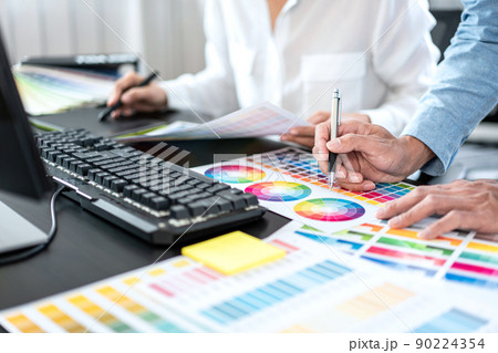 Team of creative graphic designer working on color swatch samples chart for selection coloring in inspiration to create new collection at workplace 90224354