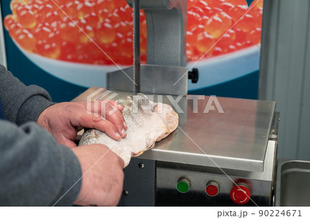 Service for cutting fish on a steak in a fish supermarket Service for cutting fish on a steak in a fish supermarket 90224671