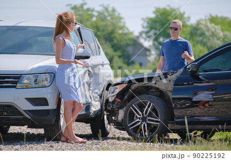 Drivers of smashed vehicles arguing who is guilty in car crash accident on street side. Road safety and insurance concept Drivers of smashed vehicles arguing who is guilty in car crash accident on street side. Road safety and insurance concept 90225192