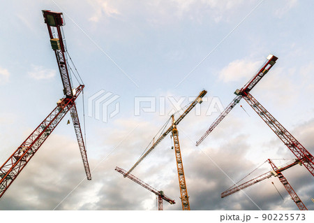 Construction tower cranes against blue sky. Industrial construction site 90225573