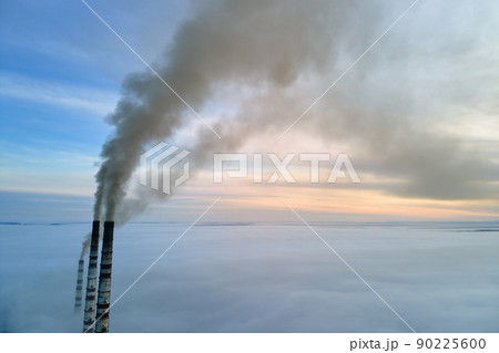Coal power plant high pipes with black smoke moving upwards polluting atmosphere. Production of electrical energy with fossil fuel concept 90225600