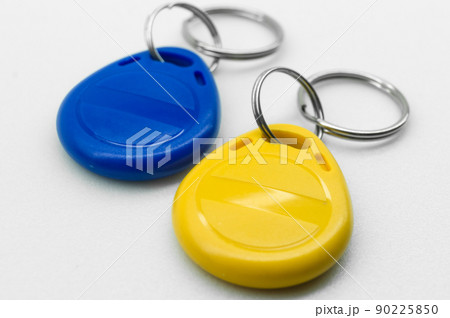 RFID tag key chain. Plastic cloned non-contact electronic radio key for intercom. NFC tag. Ukrain flag colors. Selective focus 90225850