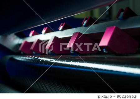 Thermal Transfer Ribbon Slitting and Rewinding Machine. Film cutting unit. A group of blades of a working machine for cutting ribbons. Selective focus 90225852