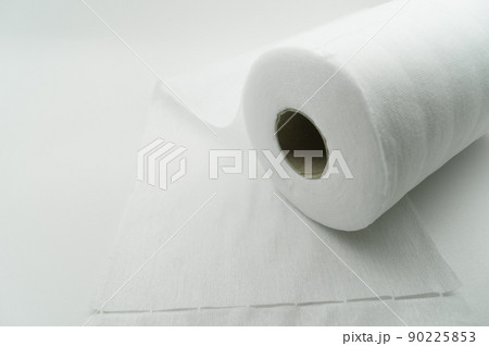 Universal white fabric napkins for cleaning in a roll. Bobbin with napkins for dispenser. Selective focus 90225853