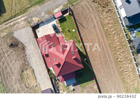 Aerial view of residential house with backyard in suburban rural area Aerial view of residential house with backyard in suburban rural area 90226432