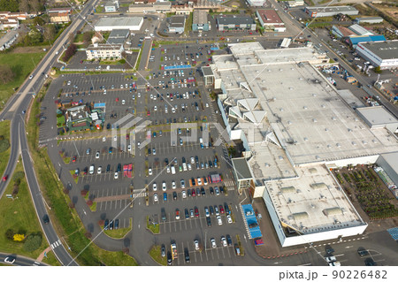 Aerial view of many colorful cars parked on parking lot with lines and markings for parking places and directions Aerial view of many colorful cars parked on parking lot with lines and markings for parking places and directions 90226482