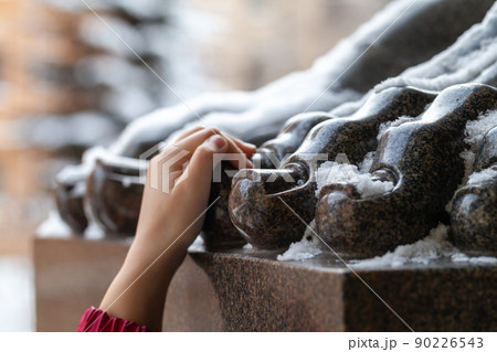 Hand holding a toe of the Atlas statue, tourist omen 90226543