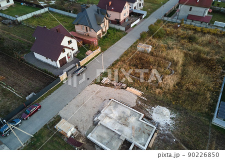 Aerial view of building works of new house concrete foundation on construction site Aerial view of building works of new house concrete foundation on construction site 90226850