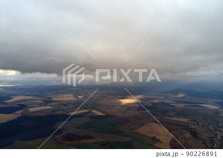 Aerial view from high altitude of earth covered with puffy rainy clouds forming before rainstorm Aerial view from high altitude of earth covered with puffy rainy clouds forming before rainstorm 90226891