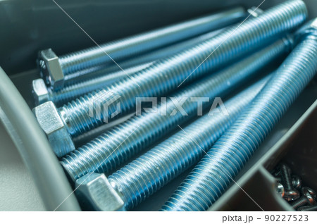 Large mounting bolts. New fasteners in the tool box. Metal bolt close-up. Selective focus Large mounting bolts. New fasteners in the tool box. Metal bolt close-up. Selective focus 90227523
