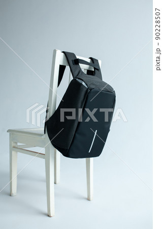 modern stylish backpack on chair studio shot 90228507