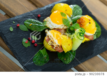Close up of mini burgers from quail eggs with baked potatoes at plate with greens Close up of mini burgers from quail eggs with baked potatoes at plate with greens 90230078
