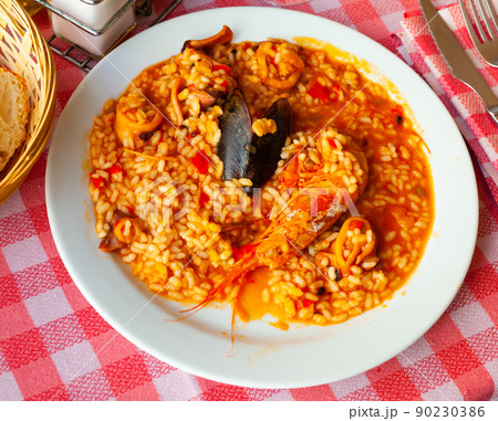 Paella on white plate Paella on white plate 90230386