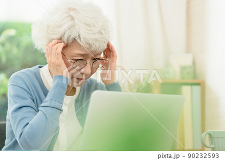 パソコンに向かう体調不良のシニア女性 90232593