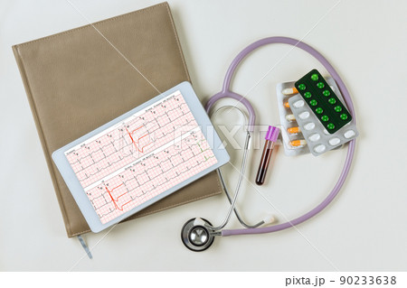 An heart report analysis the electrocardiogram viewed on digital tablet with a stethoscope An heart report analysis the electrocardiogram viewed on digital tablet with a stethoscope 90233638
