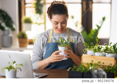 Woman caring for plants Woman caring for plants 90236076