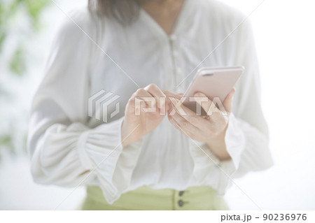 スマホを操作するミドル女性の手元 スマホを操作するミドル女性の手元 90236976
