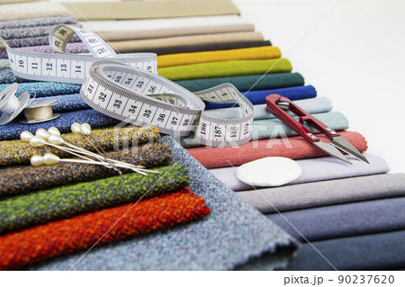 Pieces of cloth with scissors, needle and thread. Tailoring, manufacture of upholstered furniture. Pieces of cloth with scissors, needle and thread. Tailoring, manufacture of upholstered furniture. 90237620