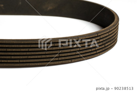 Old worn rubber alternator belt with cracks. Close up. White background 90238513